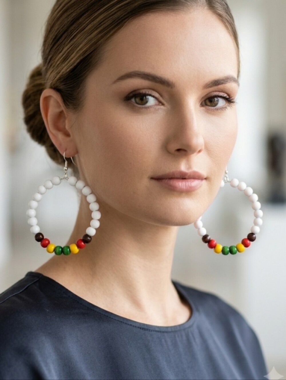 Elegant hoop earrings featuring white and multicolored wooden beads. Their light